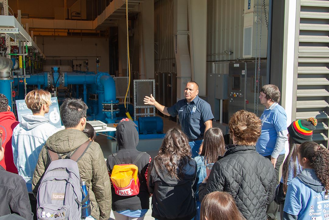 Man providing a tour to a group of students 