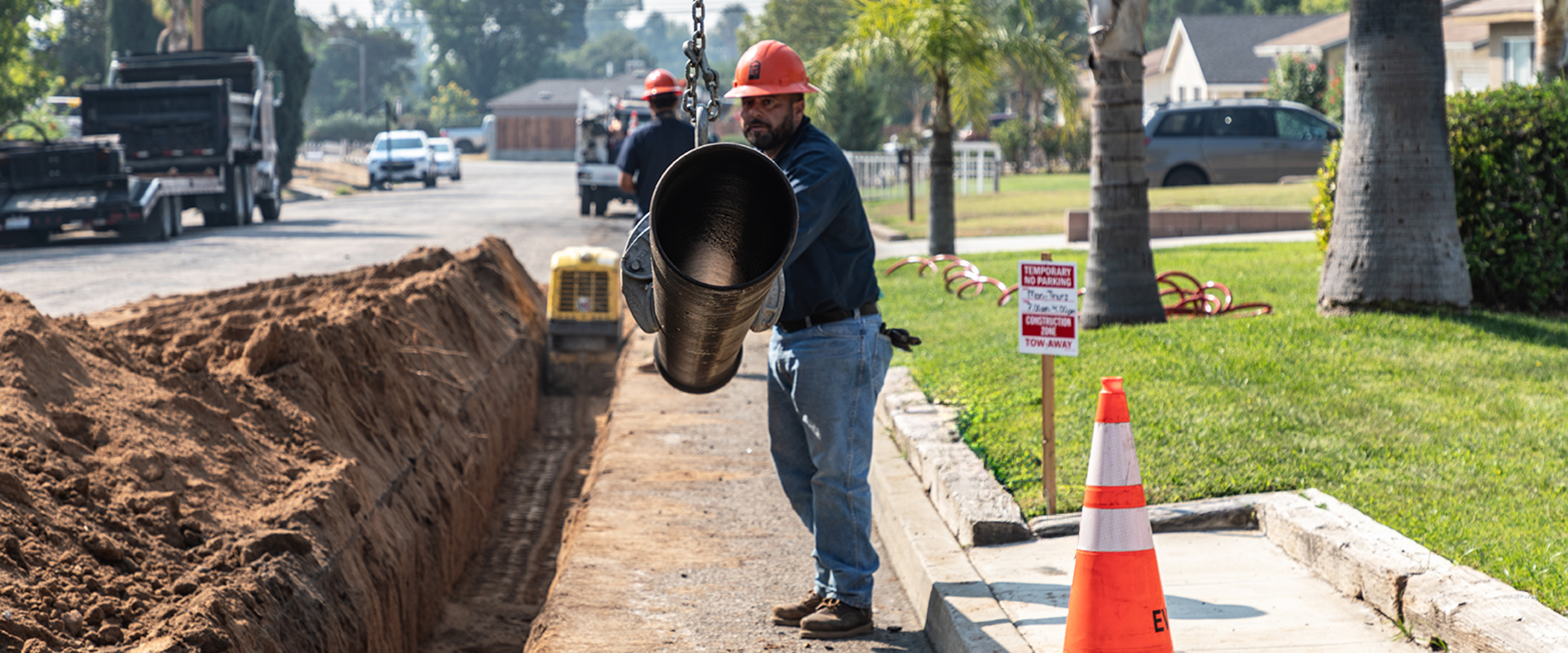 District field staff installing a new water main on a neighborhood street