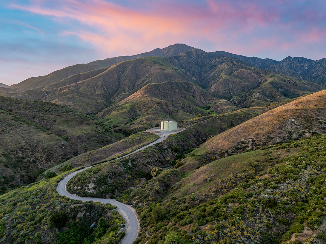 Water tank on top of a green hill