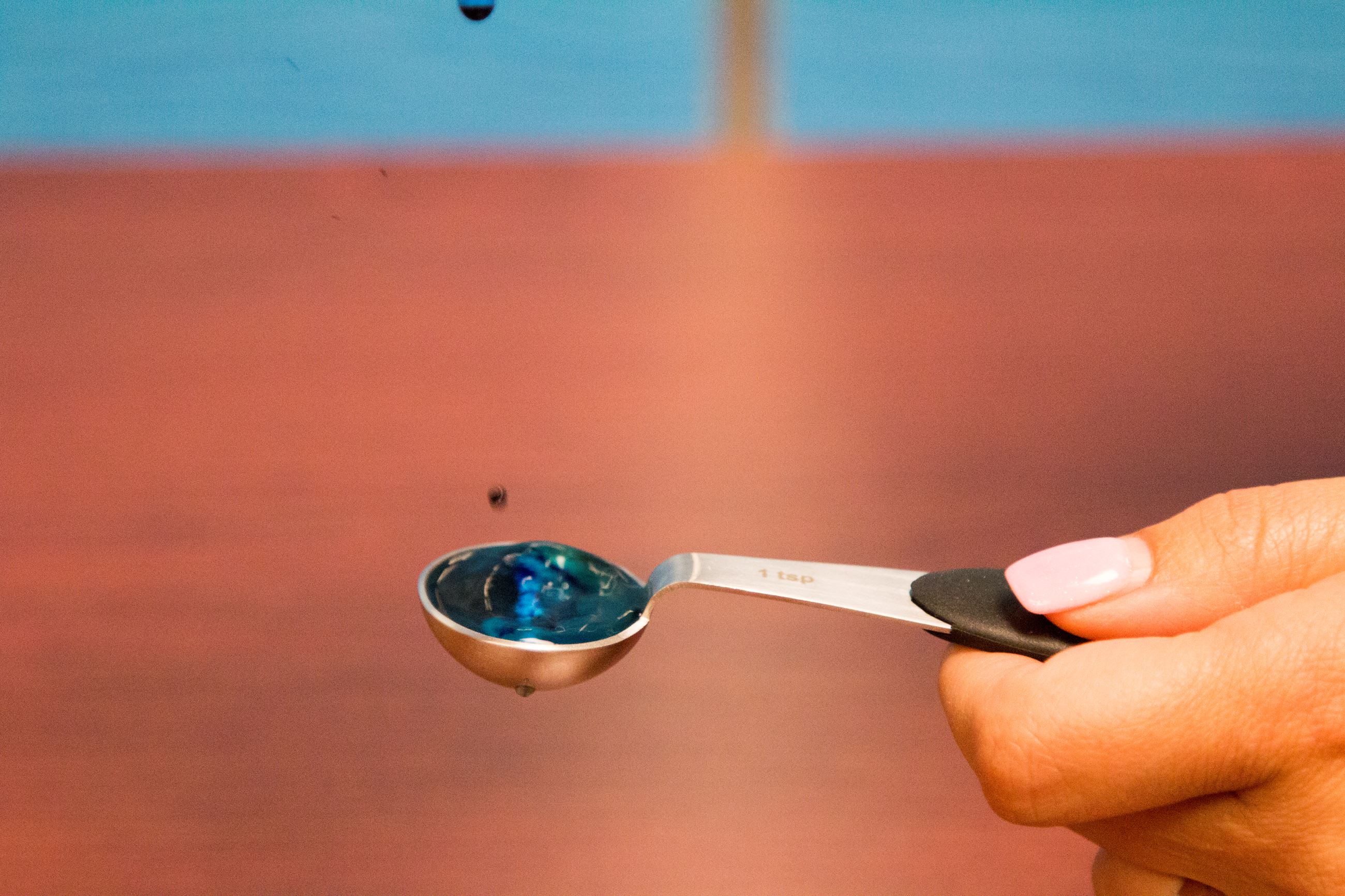 Tablespoon catching droplets of water