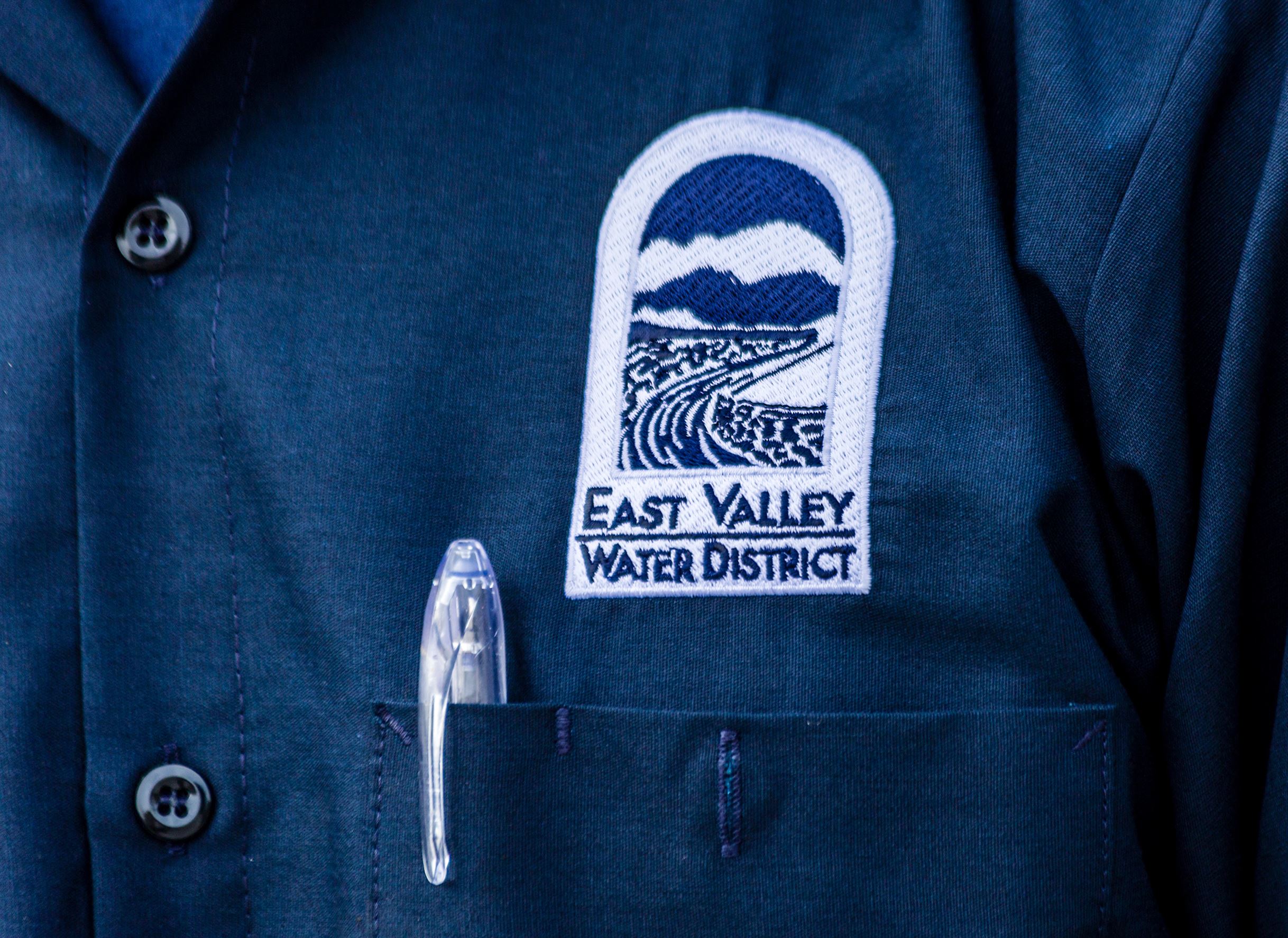 Blue shirt with an embroidered East Valley Water District emblem